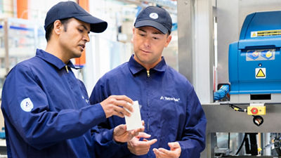 Tetra Pak operators inspecting straw on packages