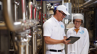 Man and woman looking at data on tablet