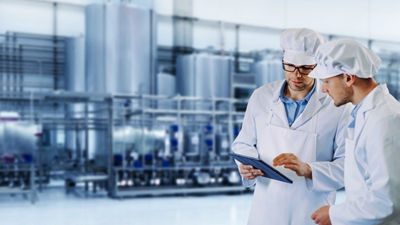 Operators with tablet, processing plant