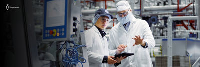 People at production site, equipment in background