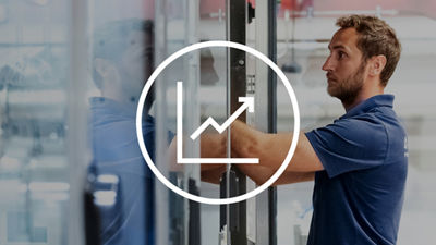 maintenance_2020-icon-1	Technician working inside an industrial machine, overlaid with an upward-trending chart icon.