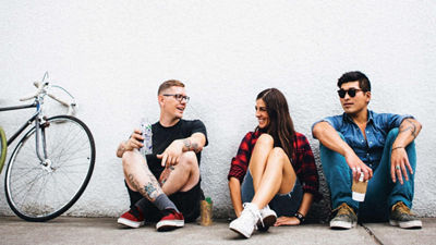 People sitting leaning against wall