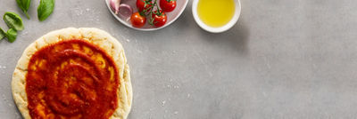 pizza dough with tomato sauce