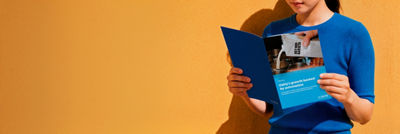 Person reading a Tetra Pak case study about Oatly's growth and automation