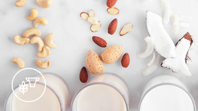 Plant-based drink in glasses raw material food sources white icon