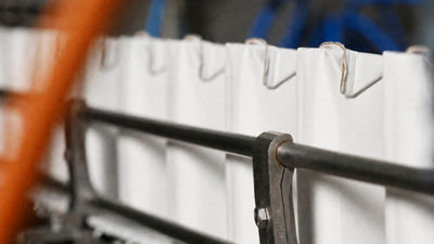 White beverage cartons moving along a production line