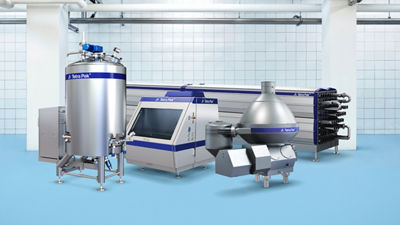 Industrial processing facility with multiple stainless steel machines in a clean equipment room