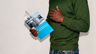 Person holding homogenizer processing brochure