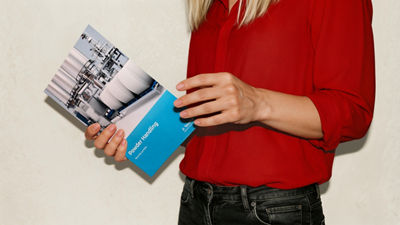 Person holding powder handling processing brochure
