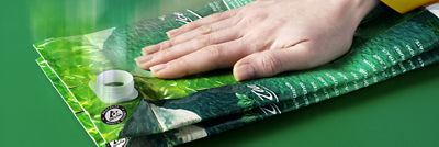 mão amassando uma caixinha longa vida pronta para ser descartada corretamente