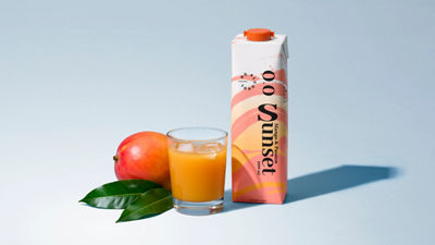 Mocktail RTD beverage in carton on grey background and a drink glass