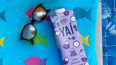 RTD tea Yai packages on towel and sunglases