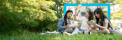 Students having a picnic in the park, coffee drinks in Tetra Pak carton packages