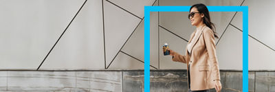 Woman walking, coffee drink in Tetra Top carton bottle, blue frame