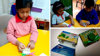School children make a wallet for Dramatic Play Learning Center