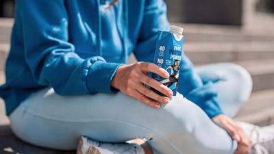 Sitting and holding sport drink in Tetra Prisma Aseptic carton