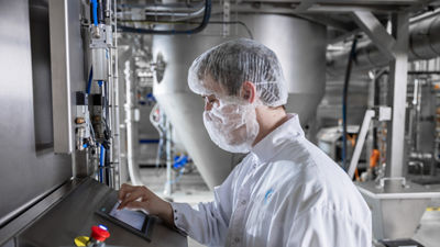 Skid-mounted spray drayer and operator, close up