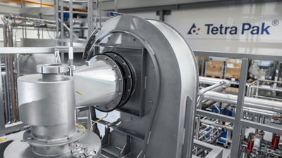 Skid-mounted spray drayer and operator, close up