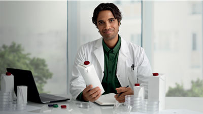 employee smiling with carton in their hand