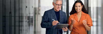colleagues talking with tablet in their hand