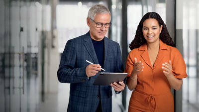 colleagues talking with tablet in their hand