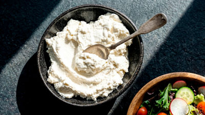 Bowl of ricotta cheese with a serving spoon.