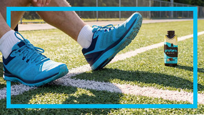 Feet with sport shoes, protein drink in Tetra Prisma Aseptic carton