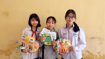 students holding waste materials