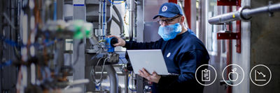 Service engineer with laptop, calibrating machine