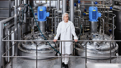 Woman standing in production hall looking out