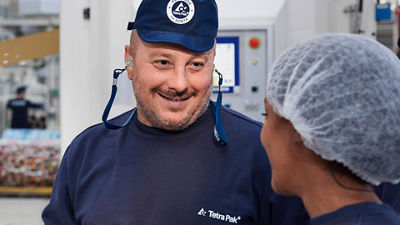Three workers talking together in a lab