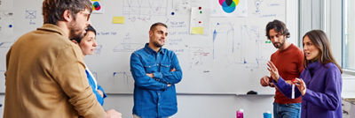 People standing in conference room talking