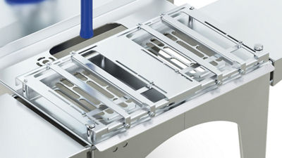 Closeup of adjustable product holders on a Tetra pak Ice Cream Robot Filler M2 equipment