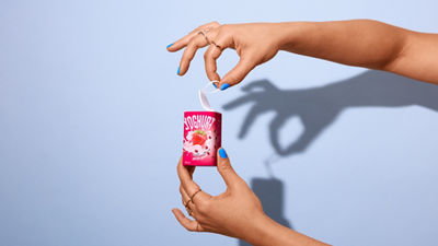 Person opening a Tetra Reva yoghurt package.