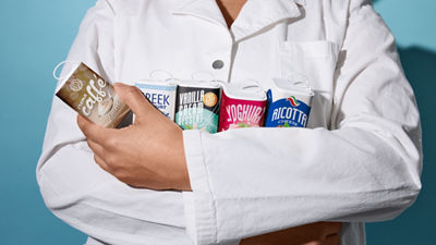 Person holding a selection of Tetra Reva food packages.