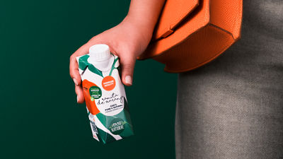 Woman holding juice carton 