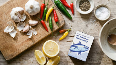 Tuna in Tetra Recart carton, lemon, garlic and chili on wooden tray