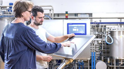 two experts in front of control panel 