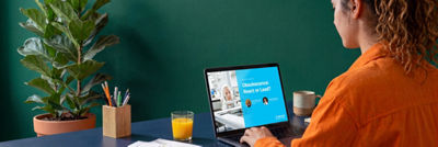 Woman viewing a Tetra Pak upgrades webinar on a laptop at her desk