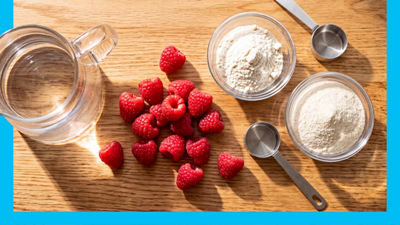 Water in jug, raspberries and protein powder