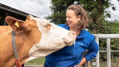 Female farmer and cow