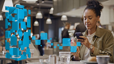 Woman with smartphone having coffee