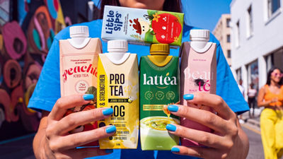 Woman with blue nails holding tea packages