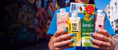 Woman hands with blue nails holding tea packages