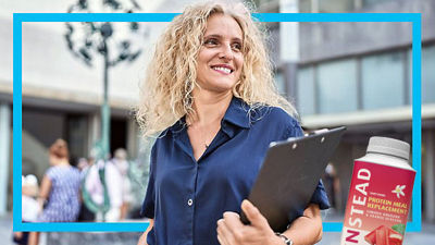 Woman with document holder, protein drink in Tetra Prisma Aseptic carton package