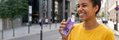 Woman on-the-go drinking iced coffee, Tetra Prisma Aseptic carton package