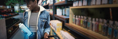 Woman in store with package in hand