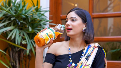 Indian woman drinking juice from  PET bottle