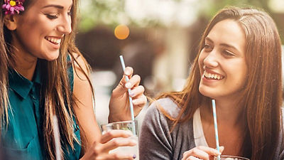 Women drinking, paper straws