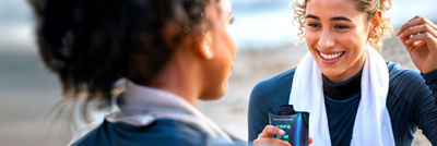 Sports women with protein drink in Tetra Prisma Aseptic carton